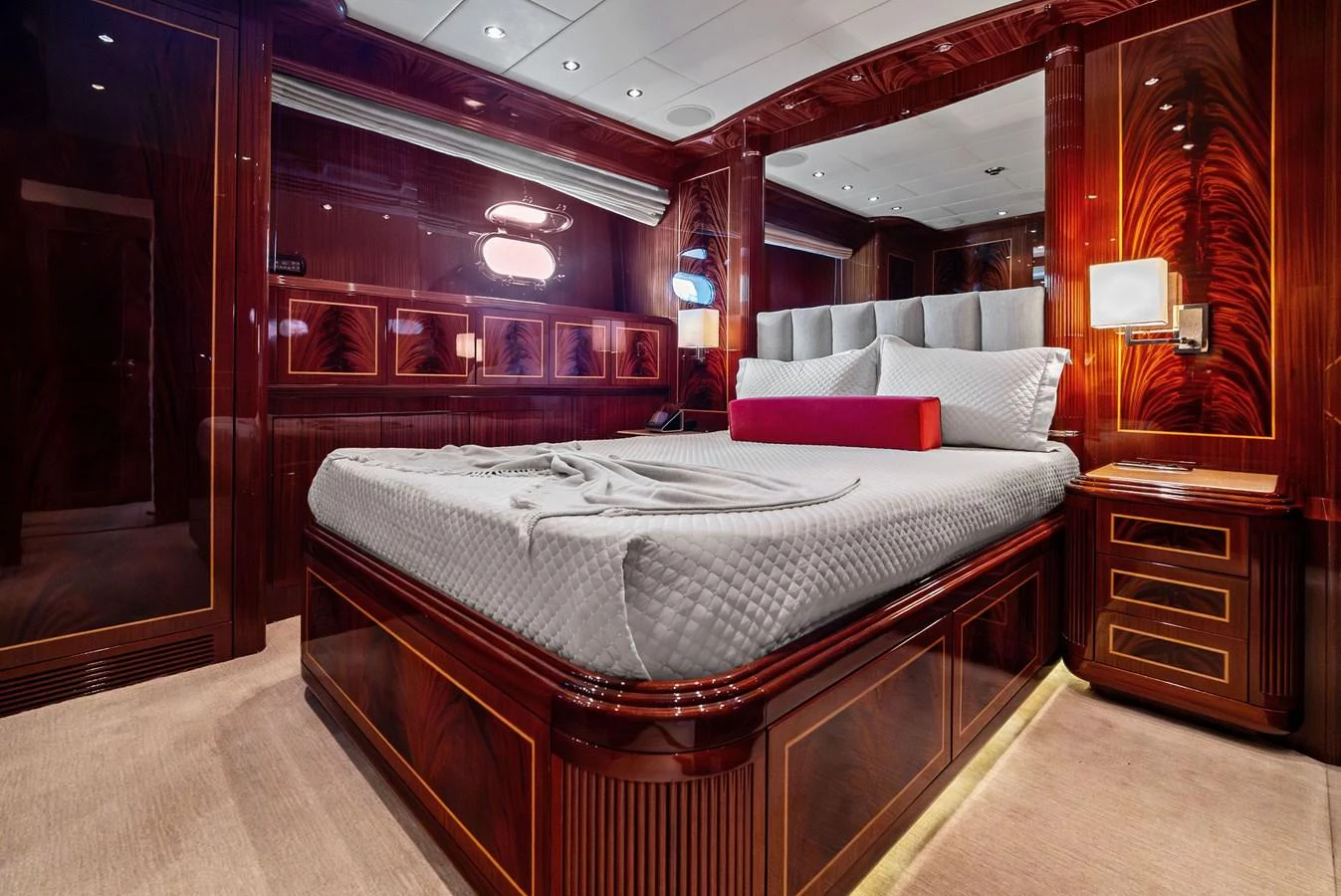 The master stateroom features luxurious wood paneling and a plush bed with elegant bedding. aboard INCOGNITO Yacht for Sale