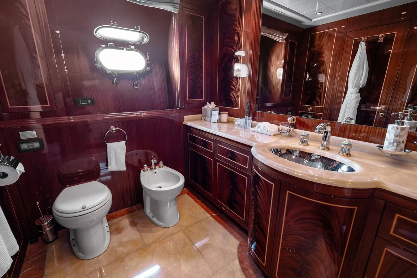 The yacht's bathroom features elegant wood paneling and luxurious fixtures. aboard INCOGNITO Yacht for Sale