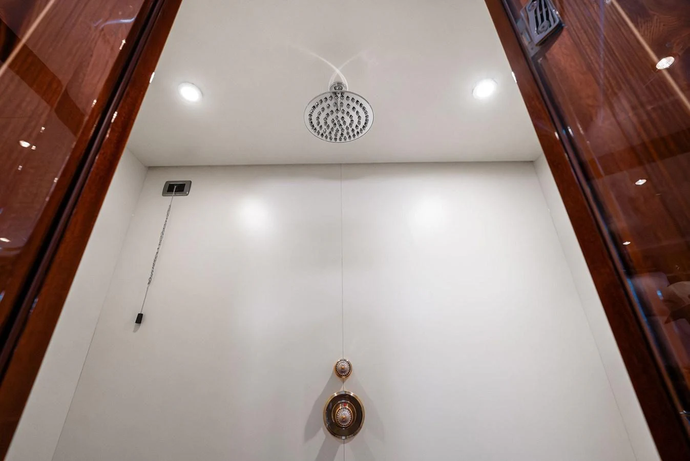 A luxurious shower area featuring a modern rain shower head and elegant fixtures. aboard INCOGNITO Yacht for Sale