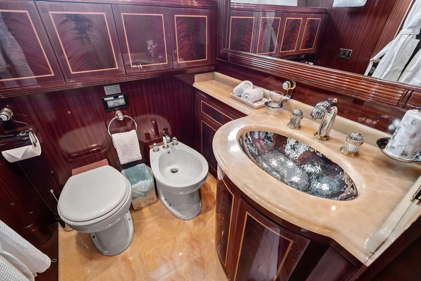 The yacht's bathroom features elegant wood paneling and luxurious fixtures. aboard INCOGNITO Yacht for Sale