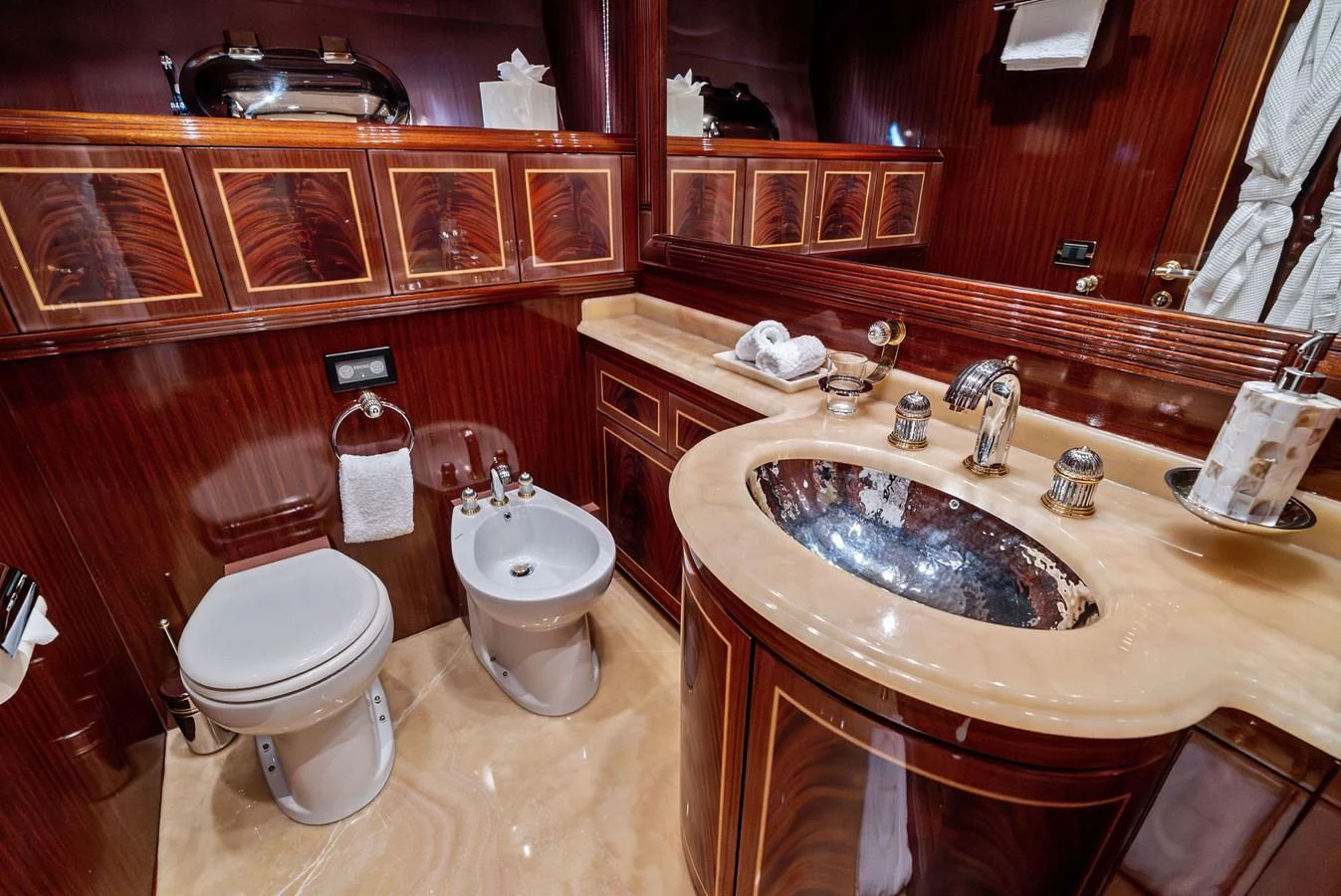 The yacht's bathroom features luxurious wood paneling and elegant fixtures. aboard INCOGNITO Yacht for Sale