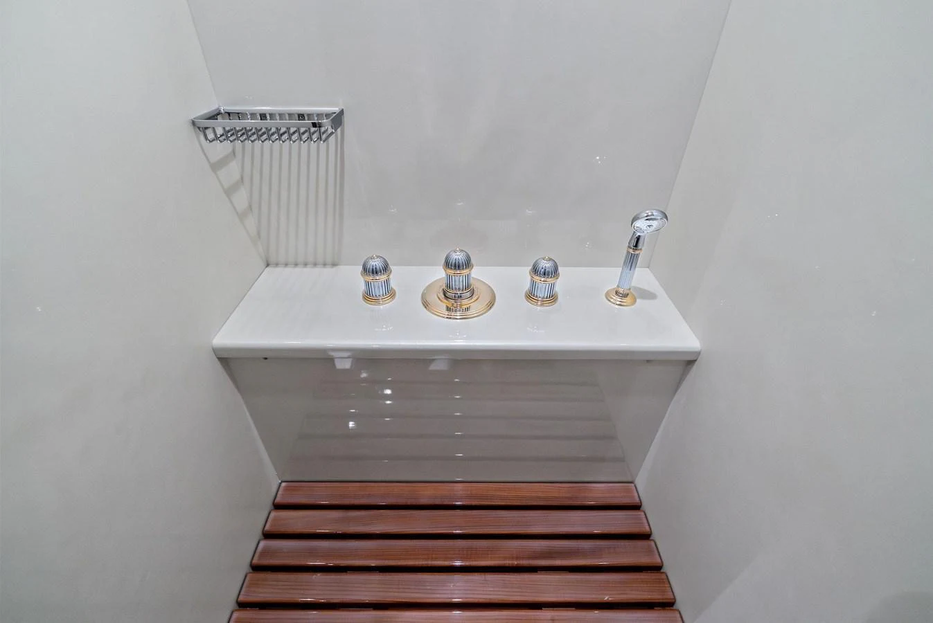 A sleek and modern shower fixture with a wooden bench, showcasing minimalist design. aboard INCOGNITO Yacht for Sale