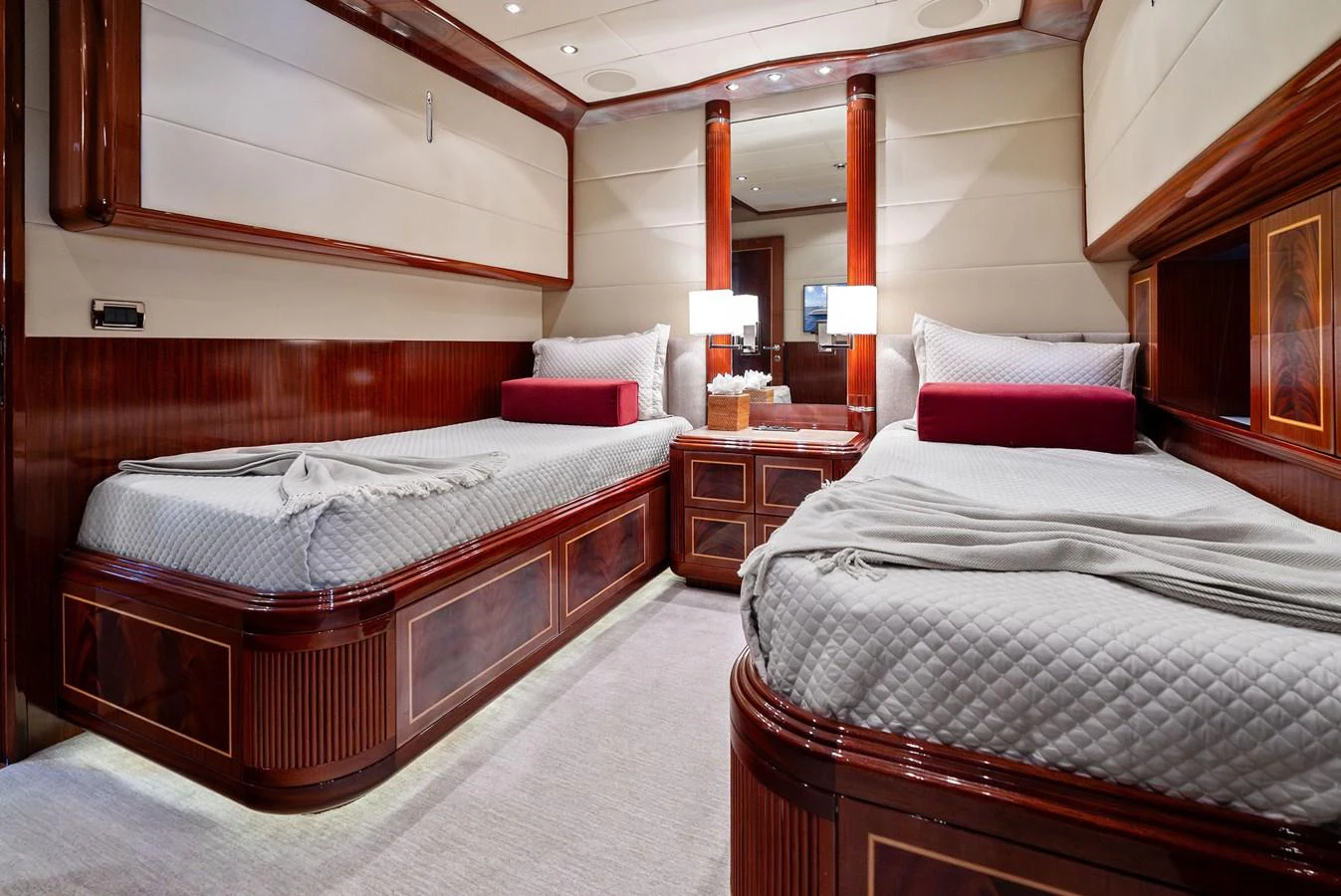 The guest stateroom features twin beds with luxurious bedding and elegant wood finishes. aboard INCOGNITO Yacht for Sale