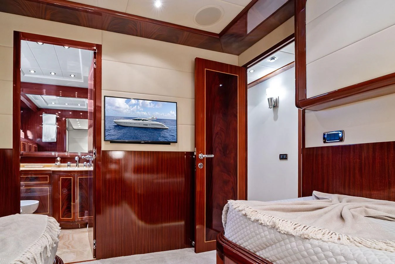 The stateroom features luxurious wood paneling, a comfortable bed, and modern amenities. aboard INCOGNITO Yacht for Sale