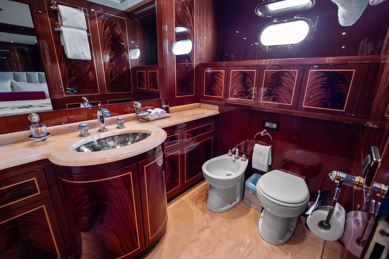 The yacht's bathroom features luxurious wood paneling and elegant fixtures. aboard INCOGNITO Yacht for Sale