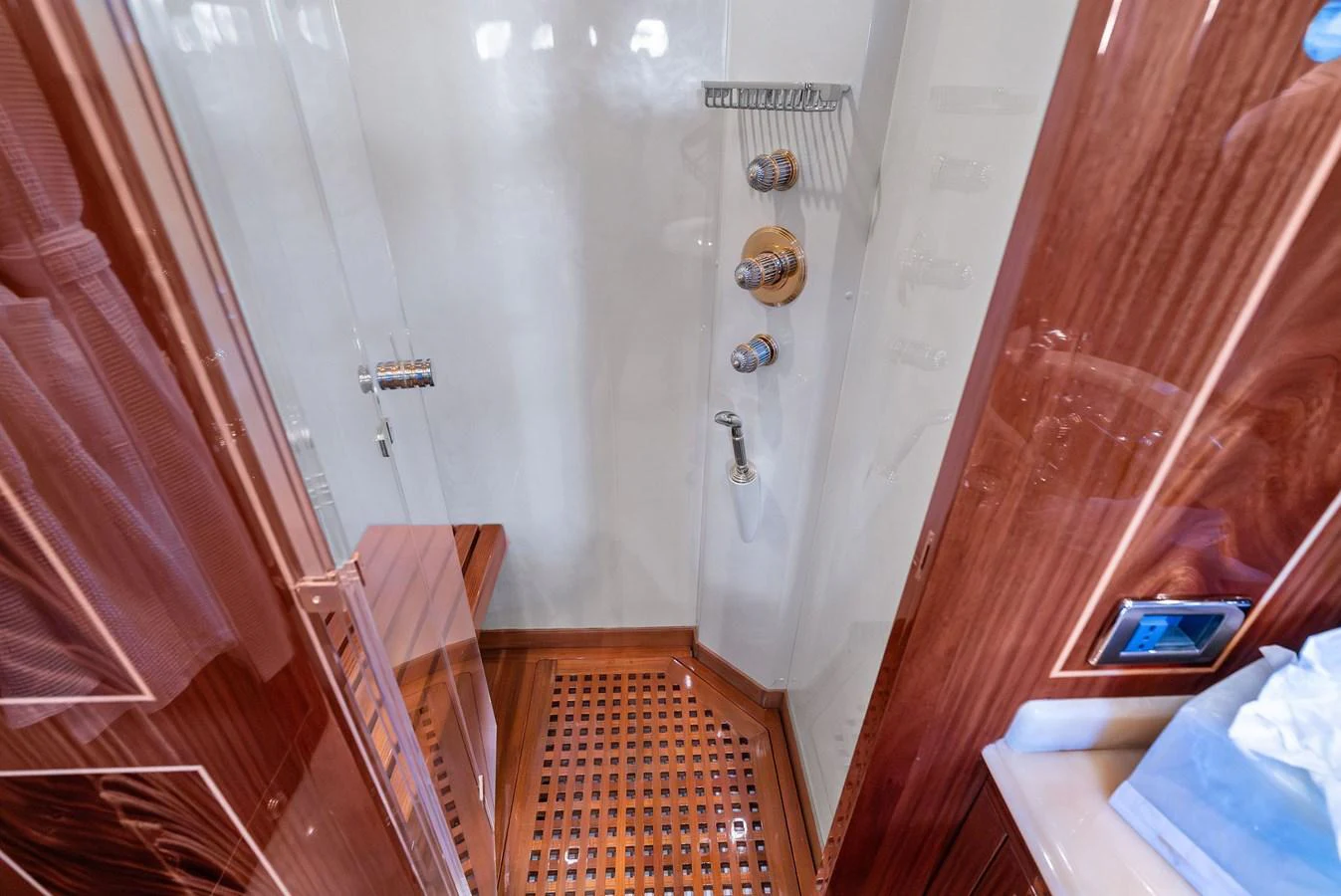 The image showcases a luxurious yacht shower with wooden accents and modern fixtures. aboard INCOGNITO Yacht for Sale