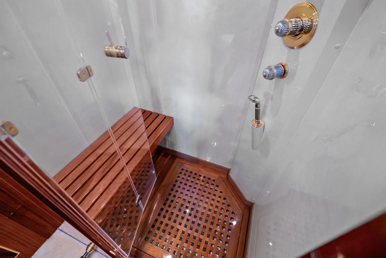 The yacht's shower features elegant wooden accents and modern fixtures. aboard INCOGNITO Yacht for Sale