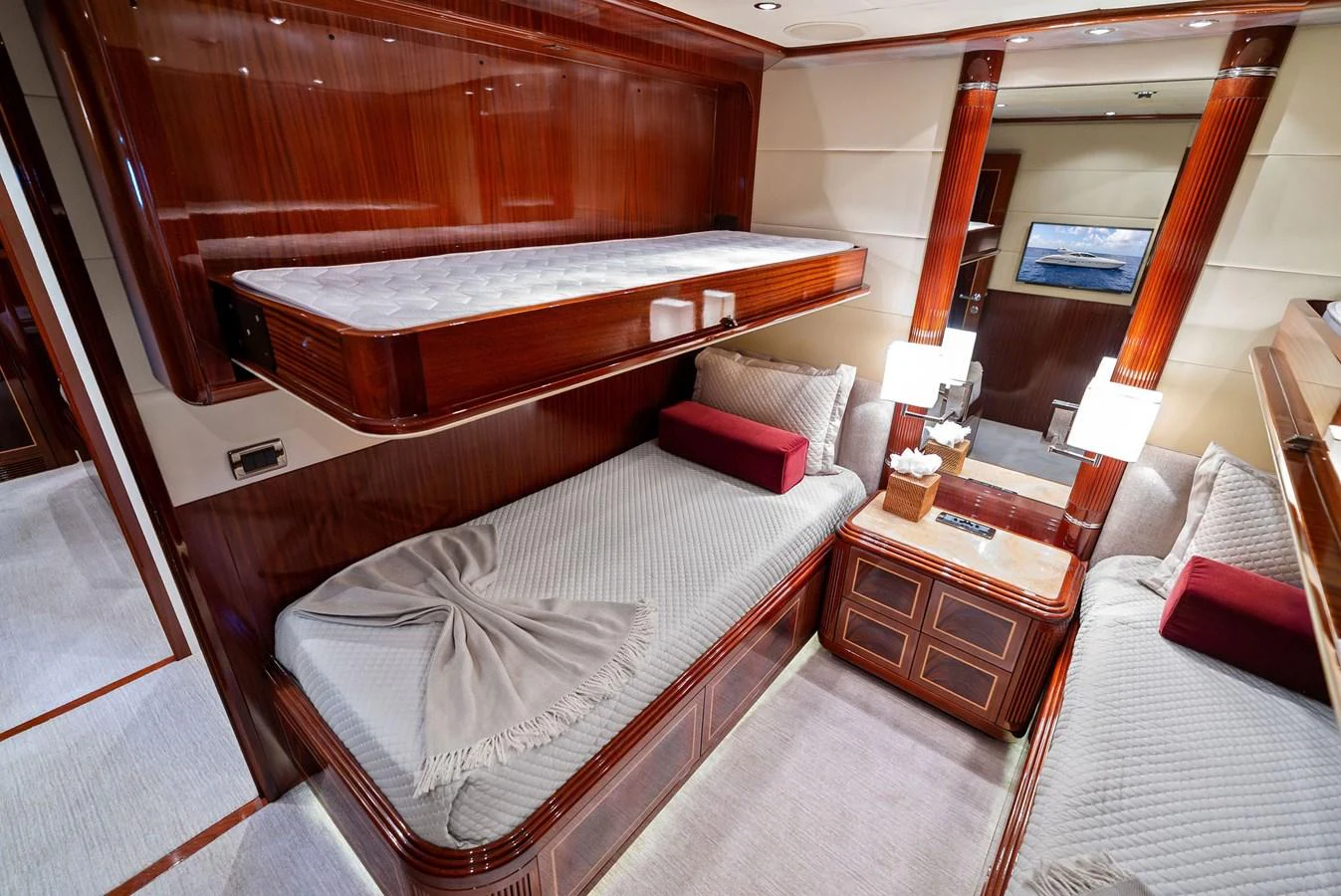 The guest cabin features twin beds with luxurious bedding and elegant wood finishes. aboard INCOGNITO Yacht for Sale