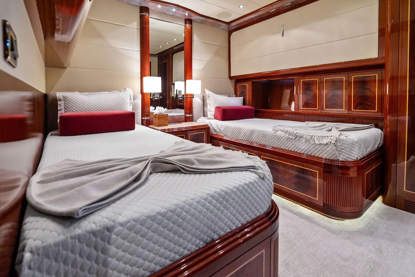 The guest stateroom features twin beds with elegant wood finishes and luxurious bedding. aboard INCOGNITO Yacht for Sale