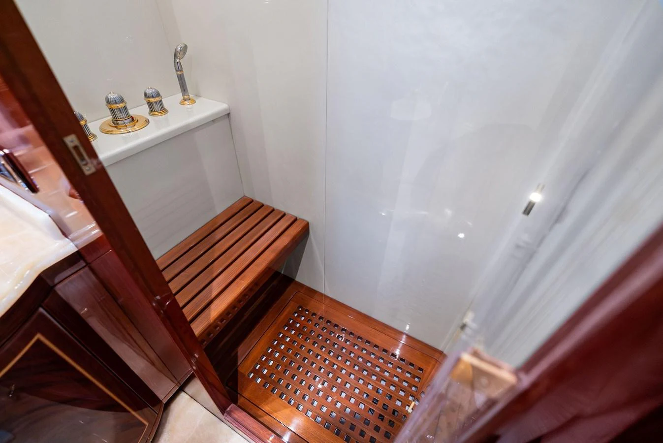 The yacht features a luxurious shower with wooden accents and modern fixtures. aboard INCOGNITO Yacht for Sale