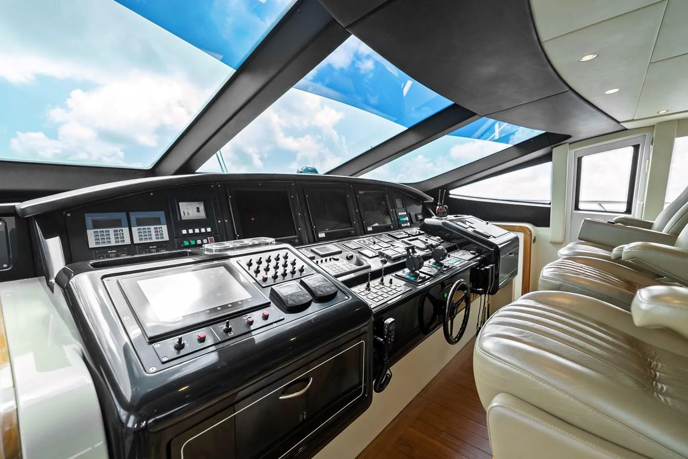 The helm station features advanced navigation equipment and luxurious seating with panoramic views. aboard INCOGNITO Yacht for Sale