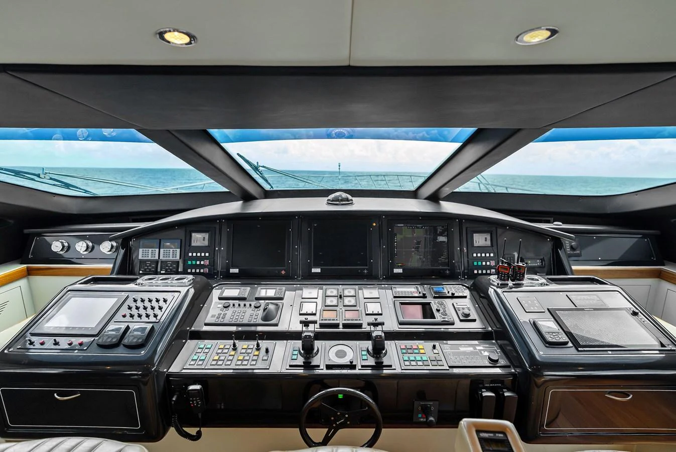 The helm station features advanced navigation and control systems with a panoramic view of the sea. aboard INCOGNITO Yacht for Sale