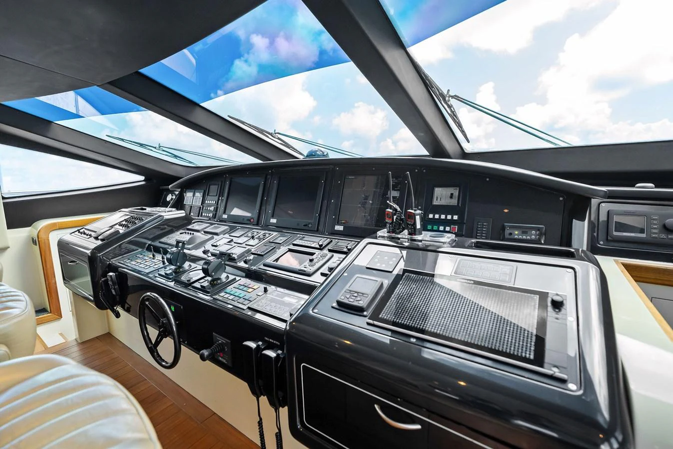 The helm station offers advanced navigation equipment and a panoramic view through large windows. aboard INCOGNITO Yacht for Sale