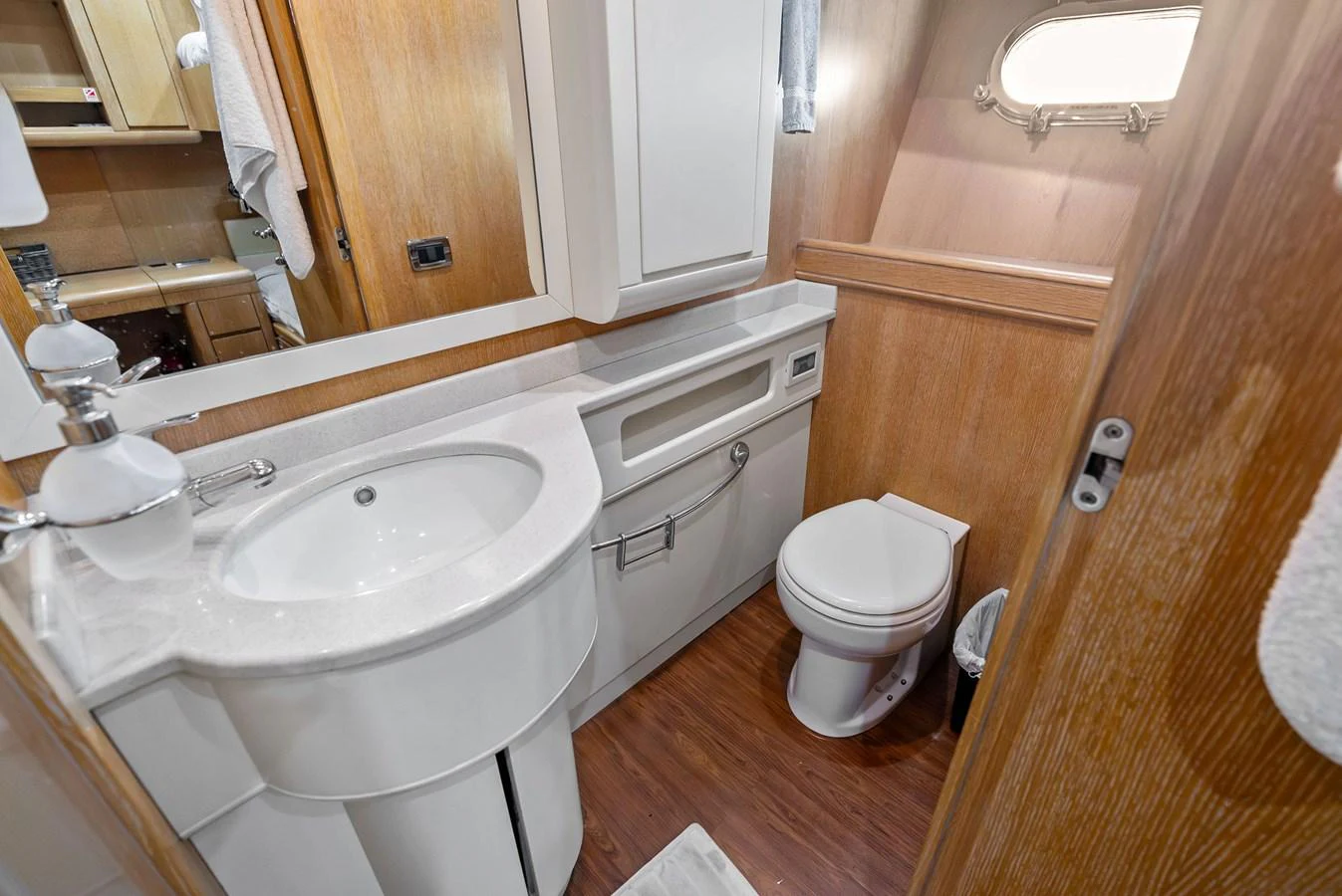 A well-appointed yacht bathroom featuring modern fixtures and wooden accents. aboard INCOGNITO Yacht for Sale