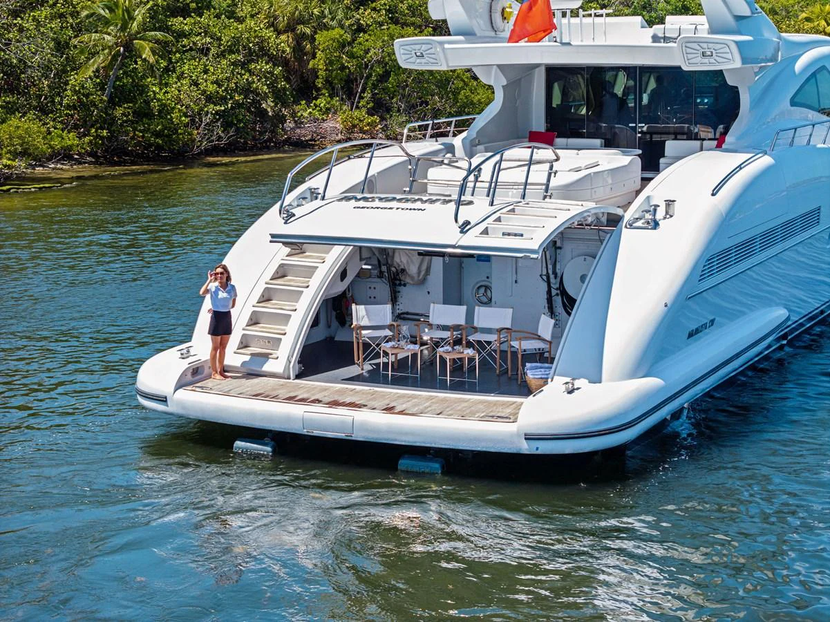 The yacht's aft deck features a spacious lounging area with a view of the serene waters. aboard INCOGNITO Yacht for Sale