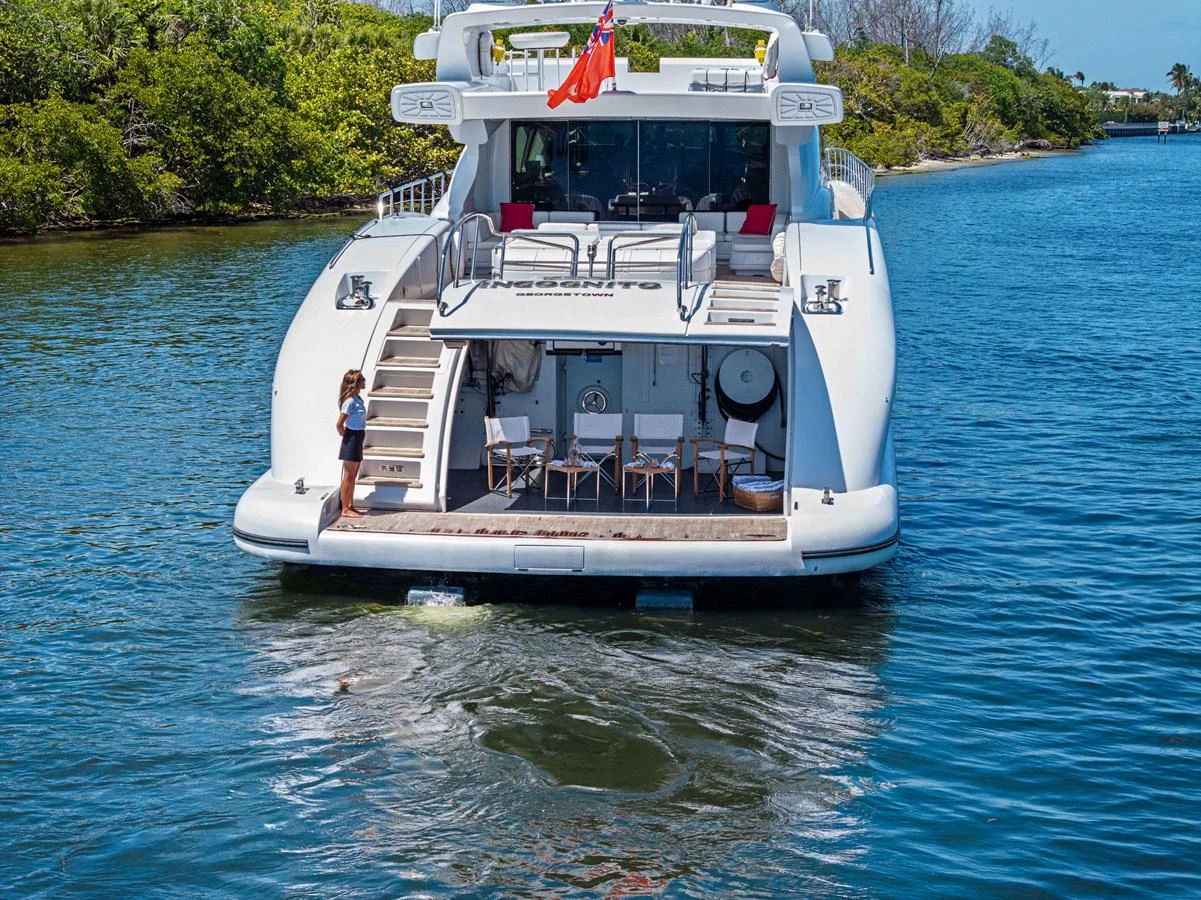 The yacht's aft deck features a spacious swim platform and inviting seating area, perfect for relaxation by the water. aboard INCOGNITO Yacht for Sale