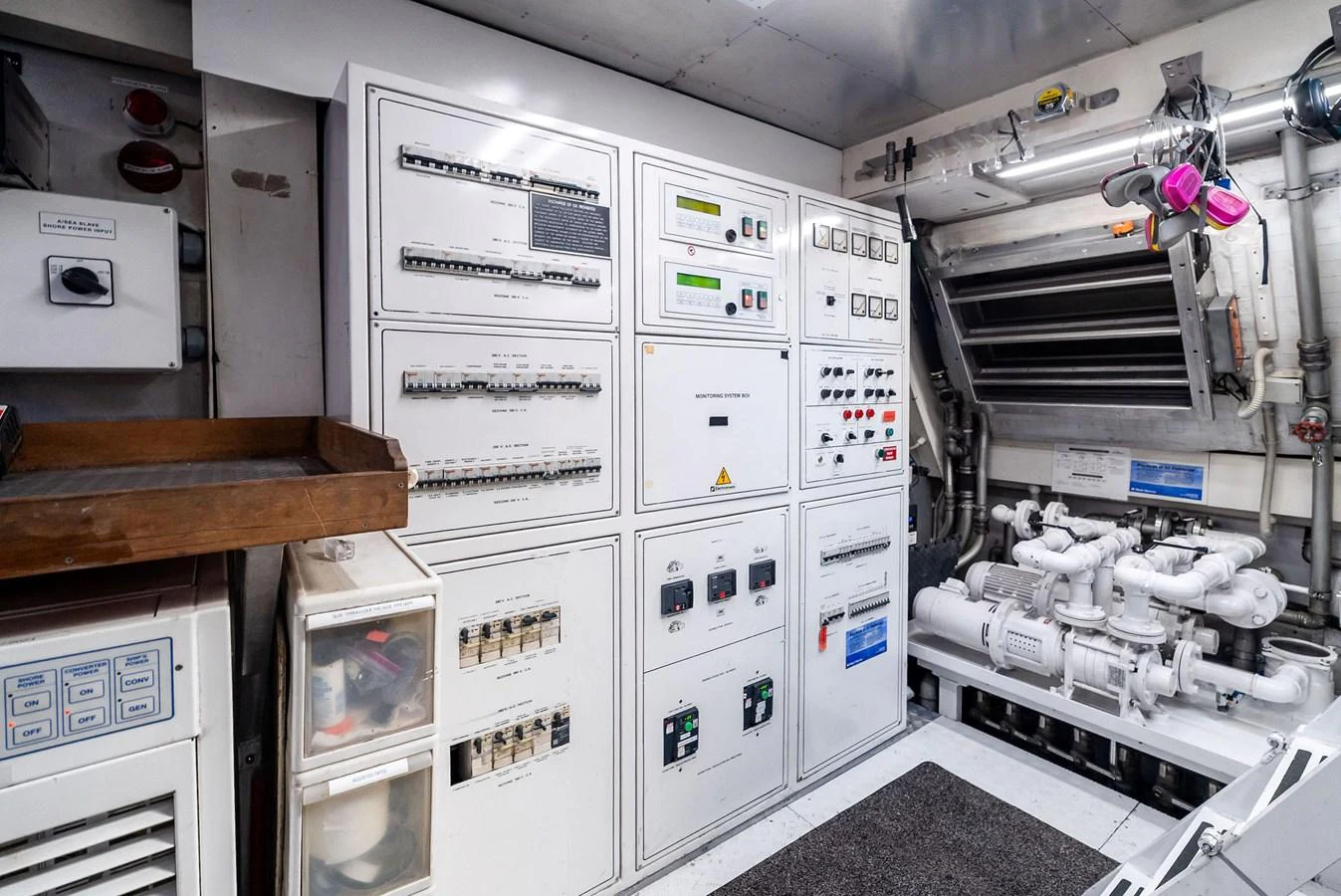 The image showcases the yacht's well-organized engine room with control panels and machinery. aboard INCOGNITO Yacht for Sale