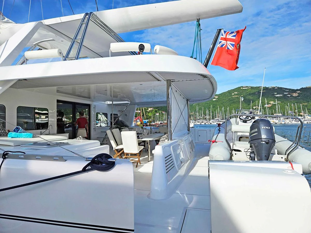 The aft deck of this yacht offers a spacious and inviting area for relaxation and socializing, with a view of the marina in the background. aboard SILHOUETTE 800 Yacht for Sale