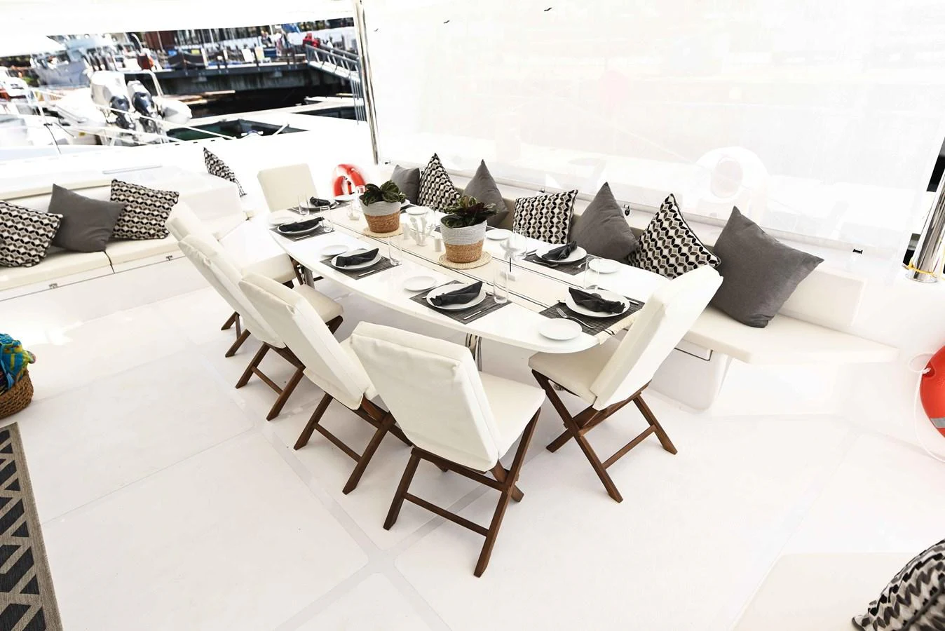 The yacht features a stylish and comfortable outdoor dining area with elegant seating arrangements. aboard SILHOUETTE 800 Yacht for Sale