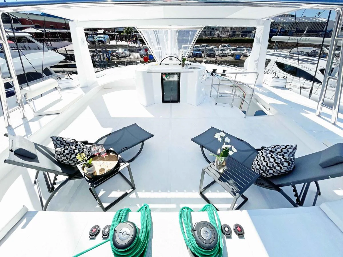The flybridge offers a luxurious lounging area with sunbeds and a mini bar, perfect for relaxation and entertainment. aboard SILHOUETTE 800 Yacht for Sale