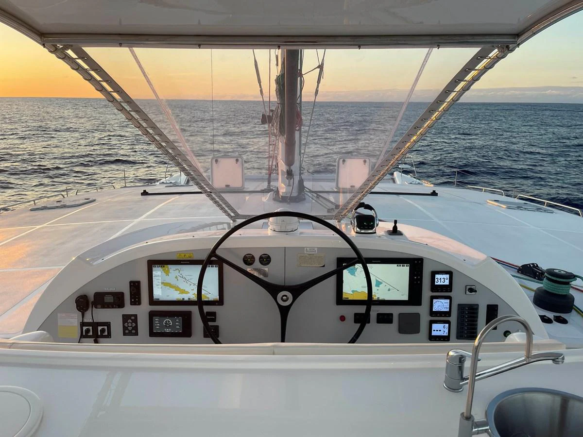 The helm station offers a commanding view of the open sea, equipped with advanced navigation instruments. aboard SILHOUETTE 800 Yacht for Sale