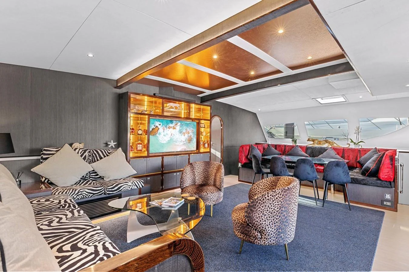 The salon features luxurious seating with a mix of patterns and textures, creating a vibrant and inviting space. aboard SILHOUETTE 800 Yacht for Sale