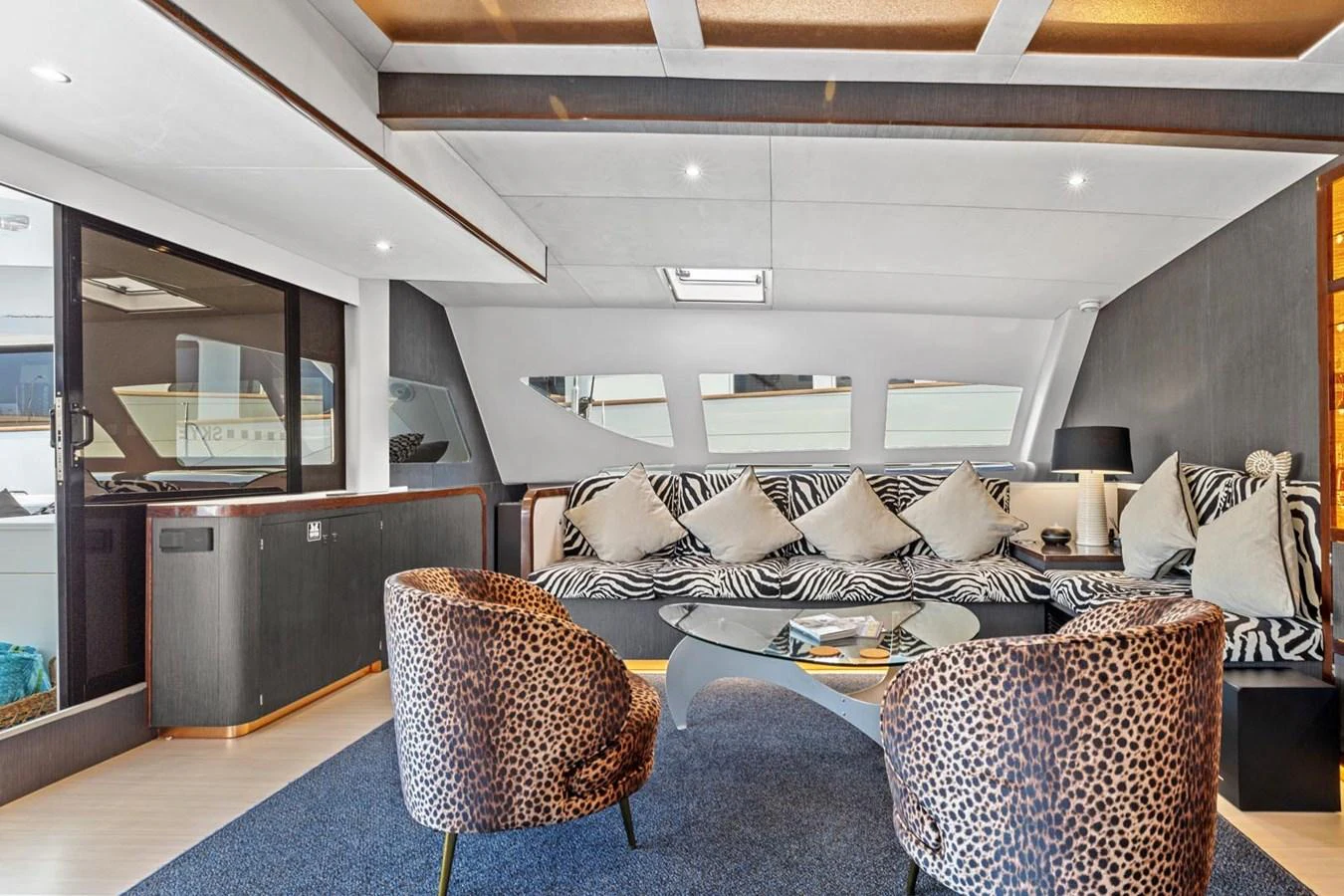 The yacht's interior features a stylish and comfortable seating area with modern decor and ample natural light. aboard SILHOUETTE 800 Yacht for Sale