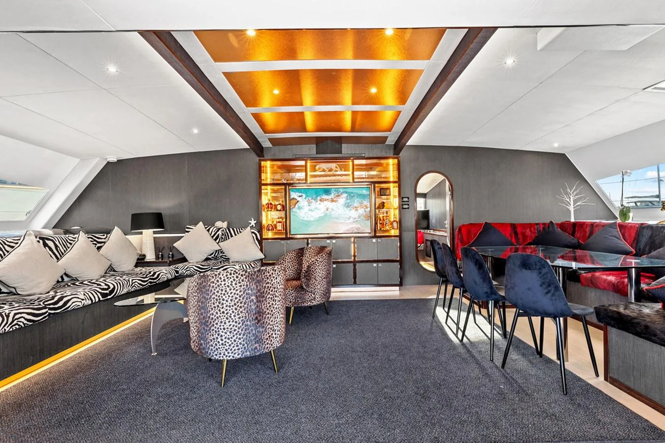 The salon features luxurious seating, a large TV, and elegant decor with ambient lighting. aboard SILHOUETTE 800 Yacht for Sale