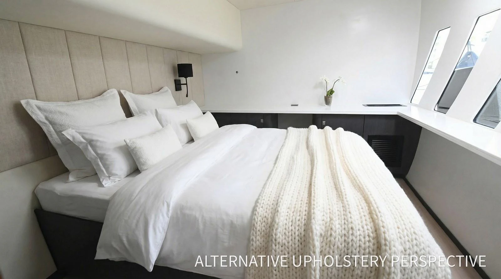 A luxurious stateroom featuring a plush bed with elegant linens and a cozy knit throw, complemented by modern decor and ample natural light. aboard SILHOUETTE 800 Yacht for Sale