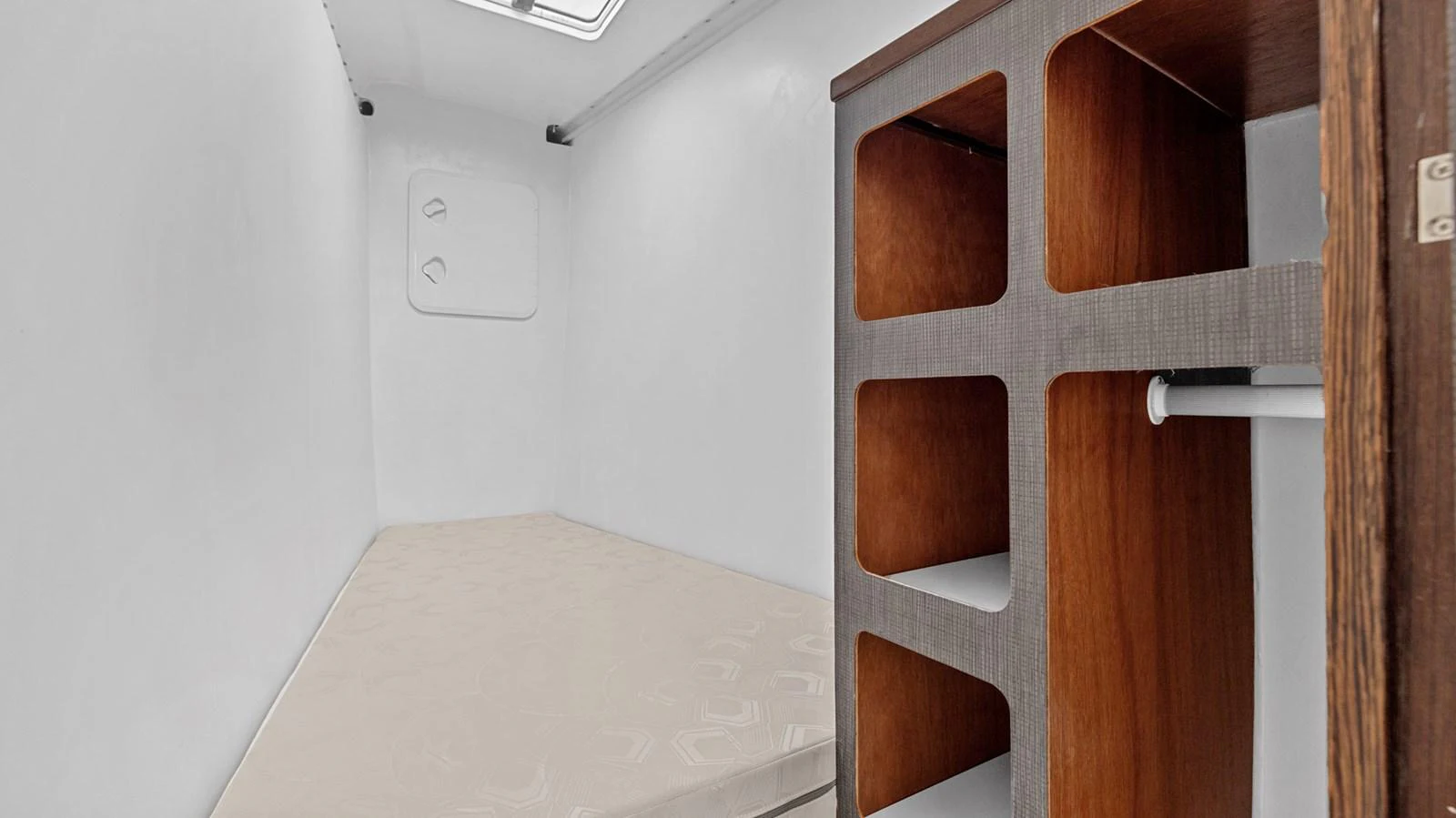A compact and functional cabin space with a simple bed and storage area. aboard SILHOUETTE 800 Yacht for Sale