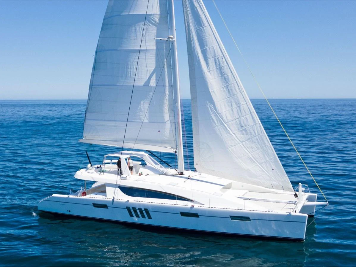 A sleek sailing yacht glides gracefully on the open sea under full sail. aboard SILHOUETTE 800 Yacht for Sale