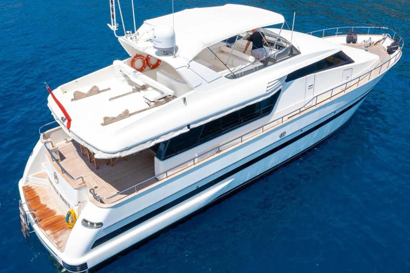 A sleek and modern yacht glides gracefully on the clear blue water. aboard BARBAROSSA MORATTI Yacht for Sale