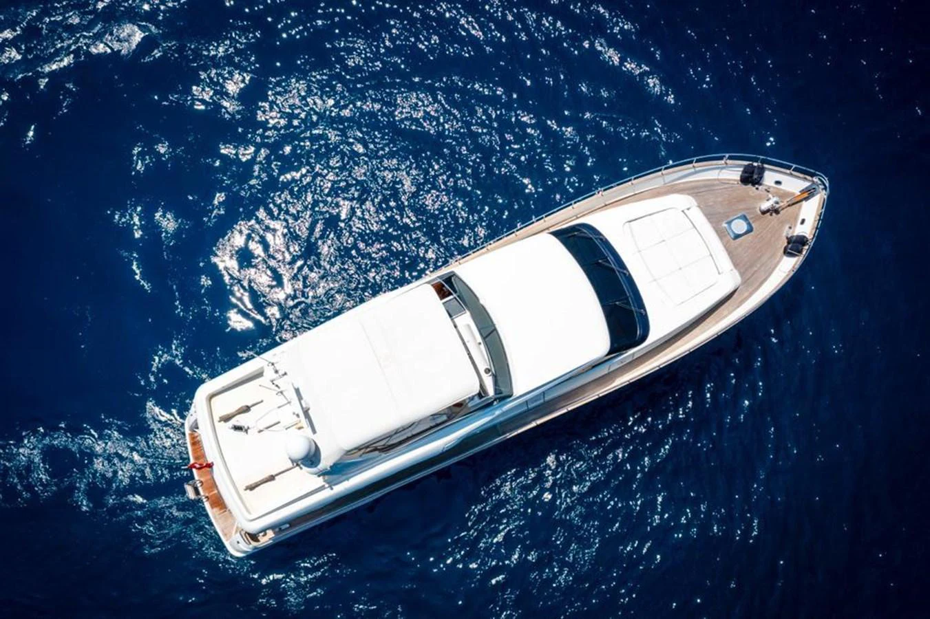 A sleek yacht glides gracefully on deep blue waters, showcasing its elegant design from an aerial perspective. aboard BARBAROSSA MORATTI Yacht for Sale