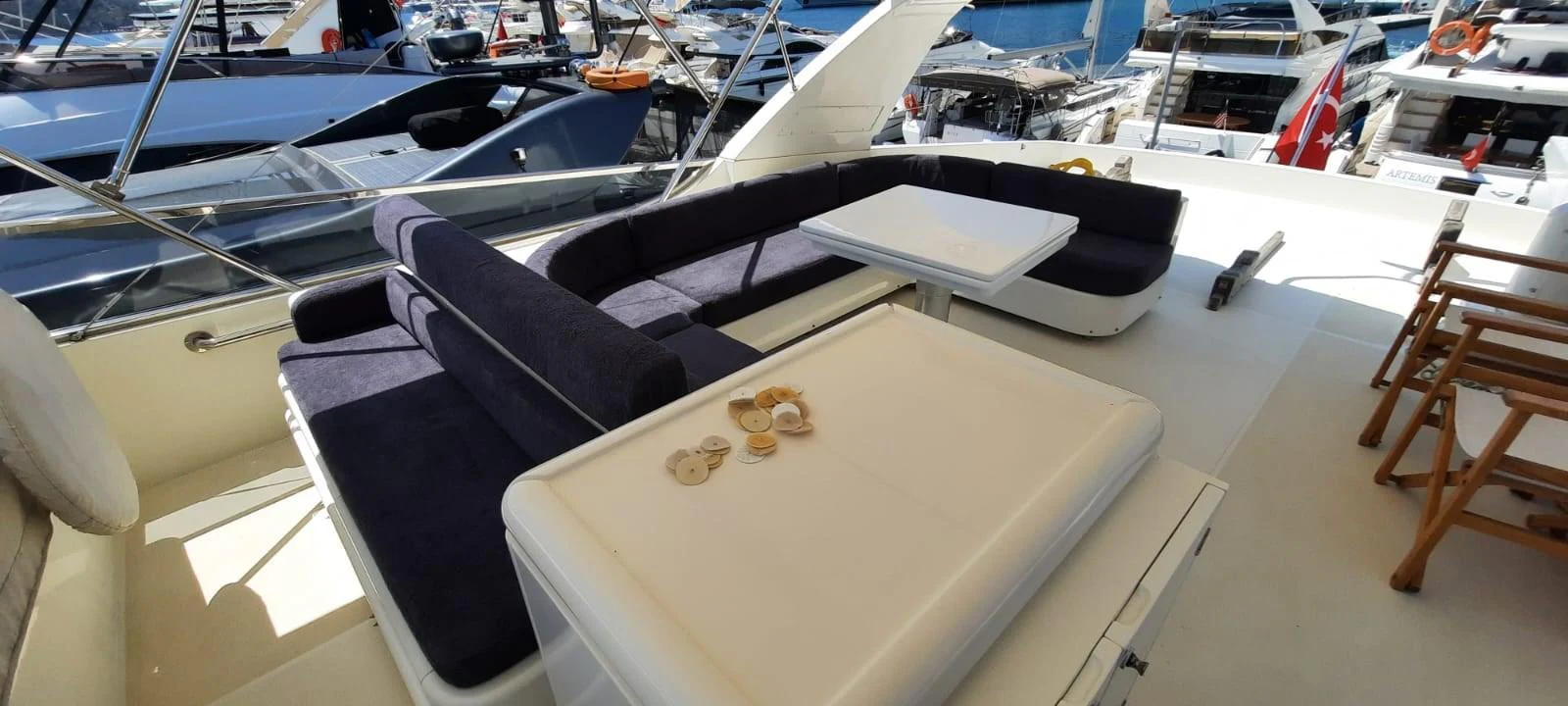 The flybridge offers a comfortable seating area with a table, perfect for outdoor relaxation and dining. aboard BARBAROSSA MORATTI Yacht for Sale