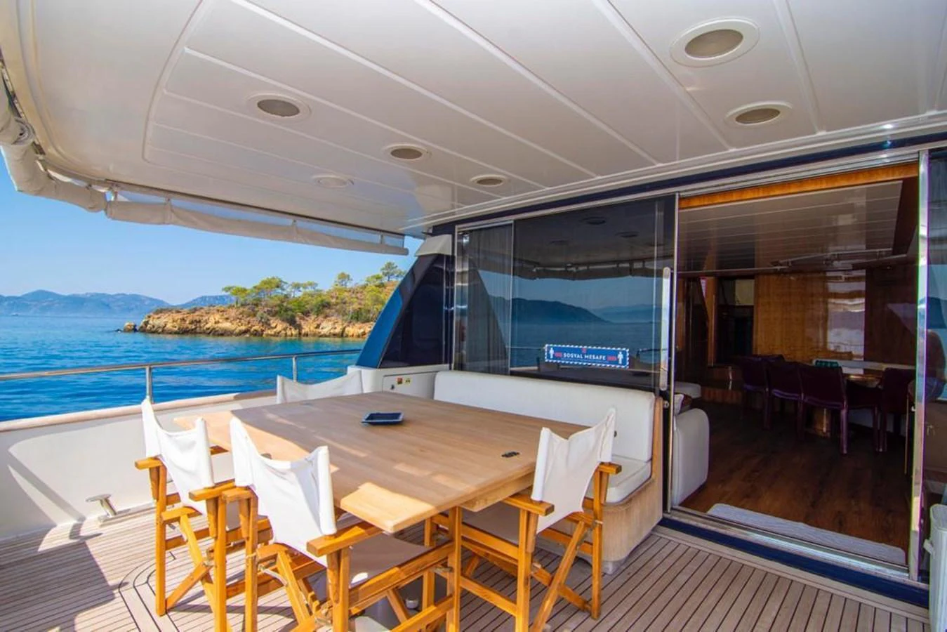 The aft deck features a spacious dining area with a beautiful view of the surrounding waters. aboard BARBAROSSA MORATTI Yacht for Sale