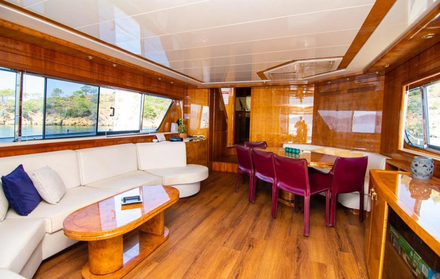 The yacht's salon features a spacious seating area with a dining table and large windows offering scenic views. aboard BARBAROSSA MORATTI Yacht for Sale