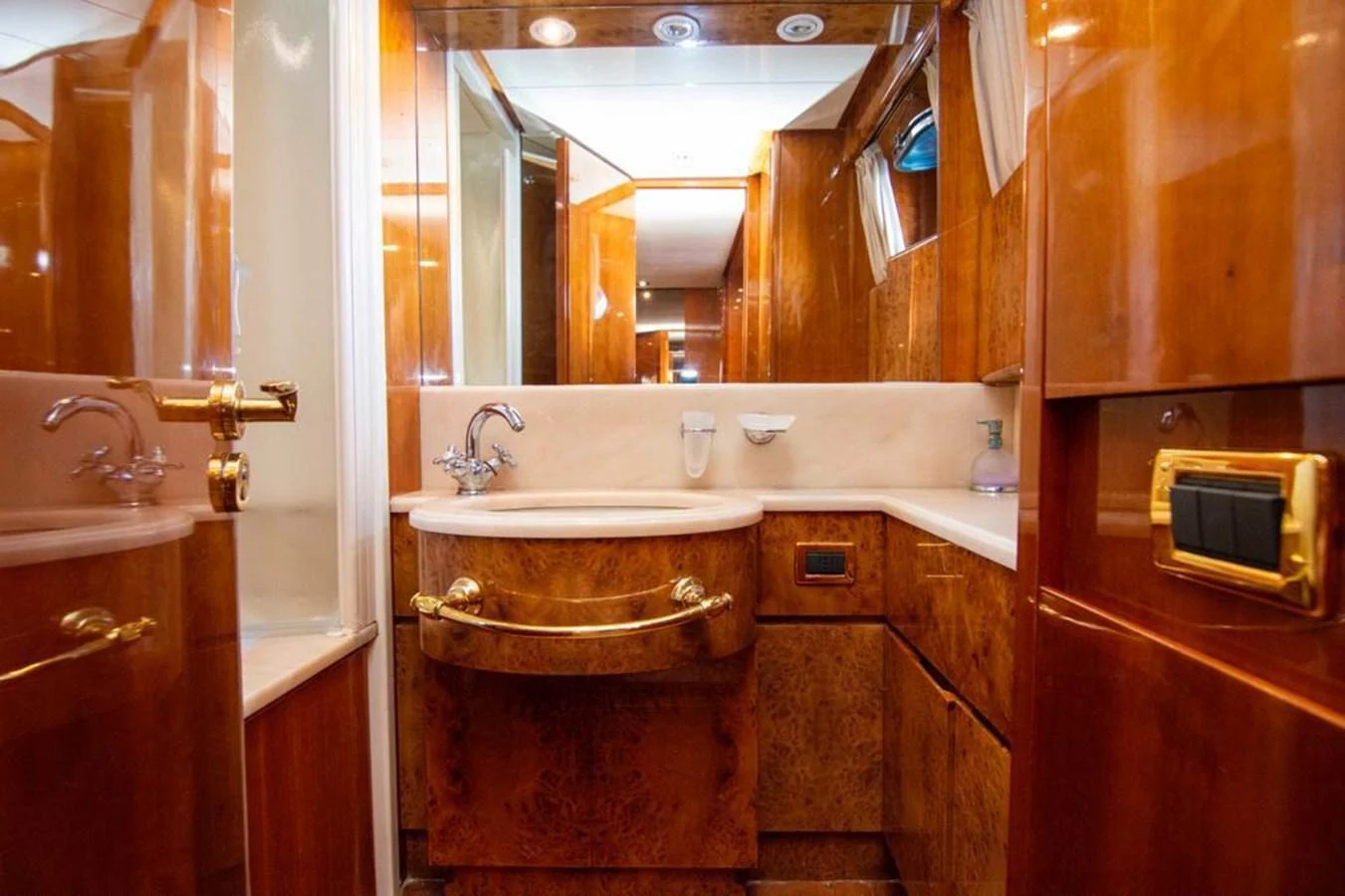 The yacht's bathroom features luxurious wood paneling and elegant fixtures. aboard BARBAROSSA MORATTI Yacht for Sale