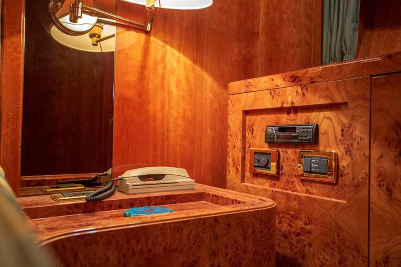 The yacht's interior features a luxurious wooden desk area with communication equipment. aboard BARBAROSSA MORATTI Yacht for Sale