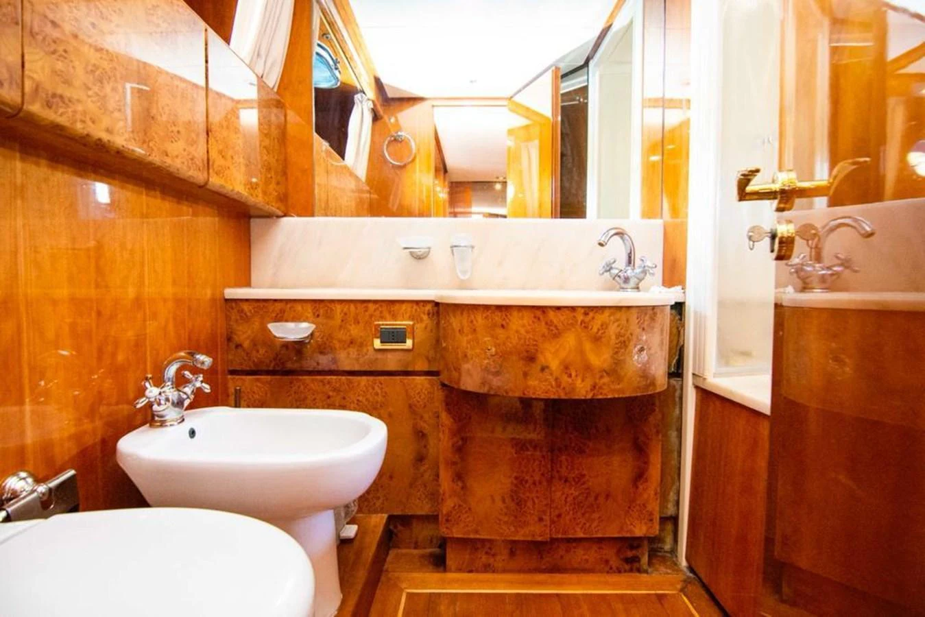 The yacht's bathroom features luxurious wood paneling and modern fixtures. aboard BARBAROSSA MORATTI Yacht for Sale