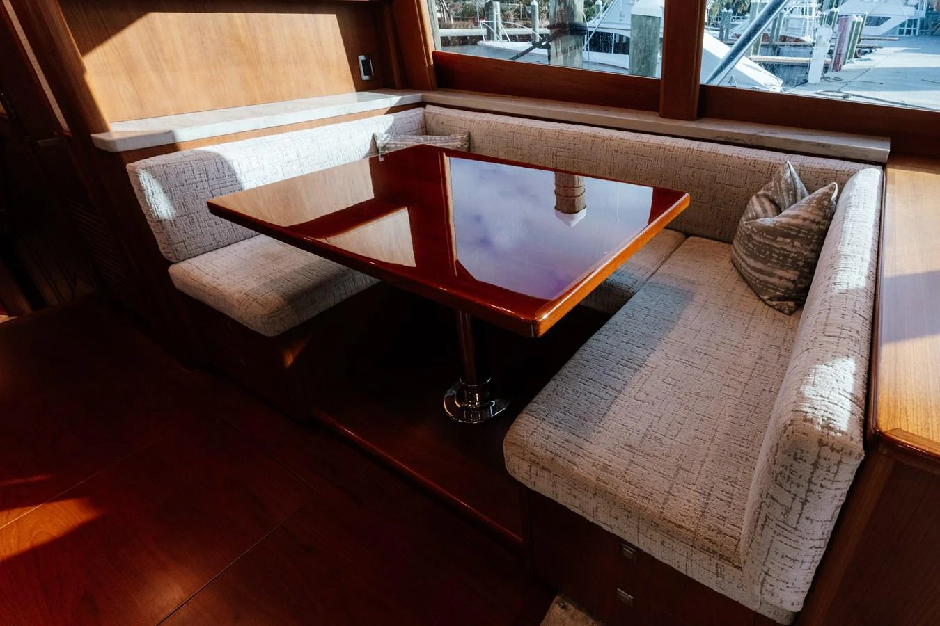 The yacht's dining area features a polished wooden table surrounded by comfortable upholstered seating. aboard NEVER SAY NEVER Yacht for Sale
