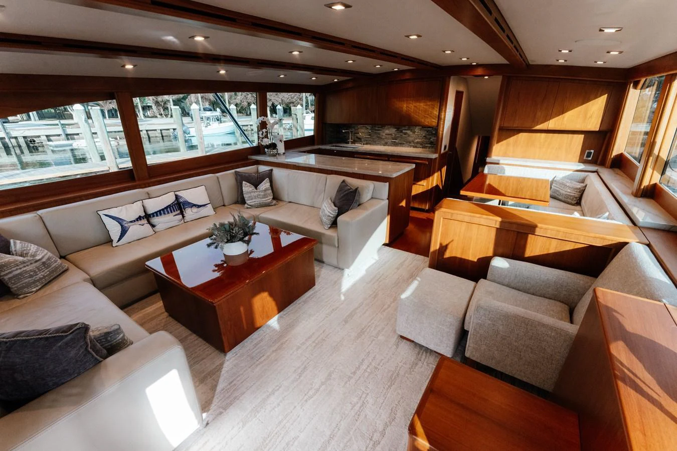 The salon features luxurious seating with ample natural light and elegant wood finishes. aboard NEVER SAY NEVER Yacht for Sale