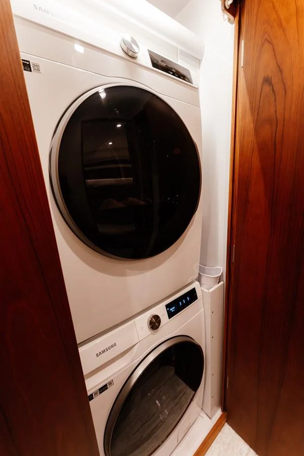 The yacht features a compact and efficient laundry area with modern appliances. aboard NEVER SAY NEVER Yacht for Sale