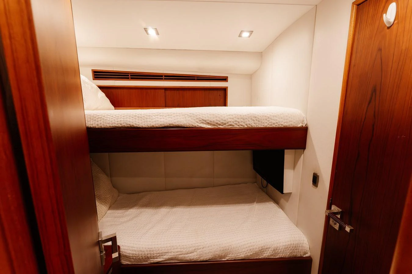 The cozy guest cabin features comfortable bunk beds with warm wooden accents. aboard NEVER SAY NEVER Yacht for Sale