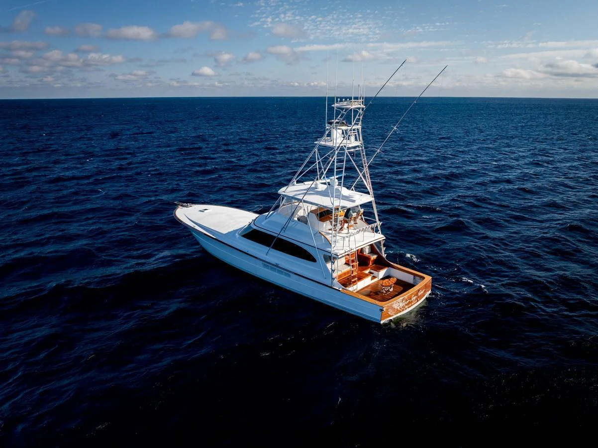 A sleek yacht cruises through deep blue waters under a clear sky. aboard NEVER SAY NEVER Yacht for Sale