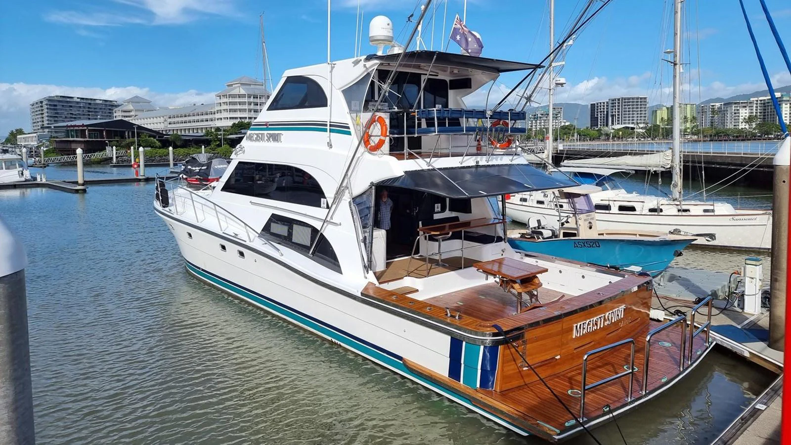 A sleek yacht docked at a marina, showcasing its elegant design and spacious aft deck. aboard MEGISTI SPIRIT Yacht for Sale