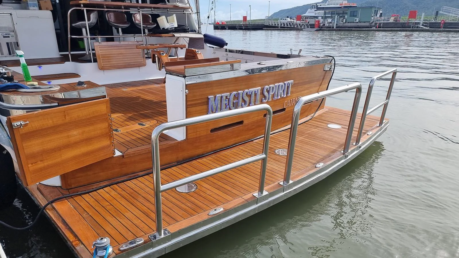 The yacht's aft deck features elegant wooden flooring and a spacious layout for relaxation. aboard MEGISTI SPIRIT Yacht for Sale