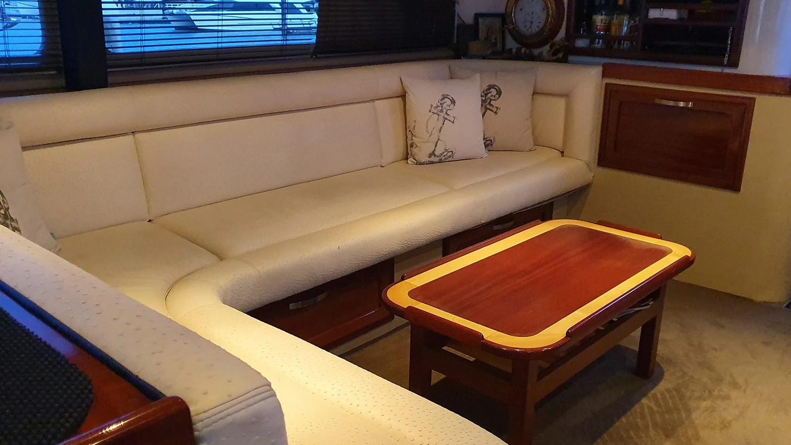 The salon features a comfortable L-shaped sofa and a wooden coffee table, creating a cozy and inviting atmosphere. aboard MEGISTI SPIRIT Yacht for Sale