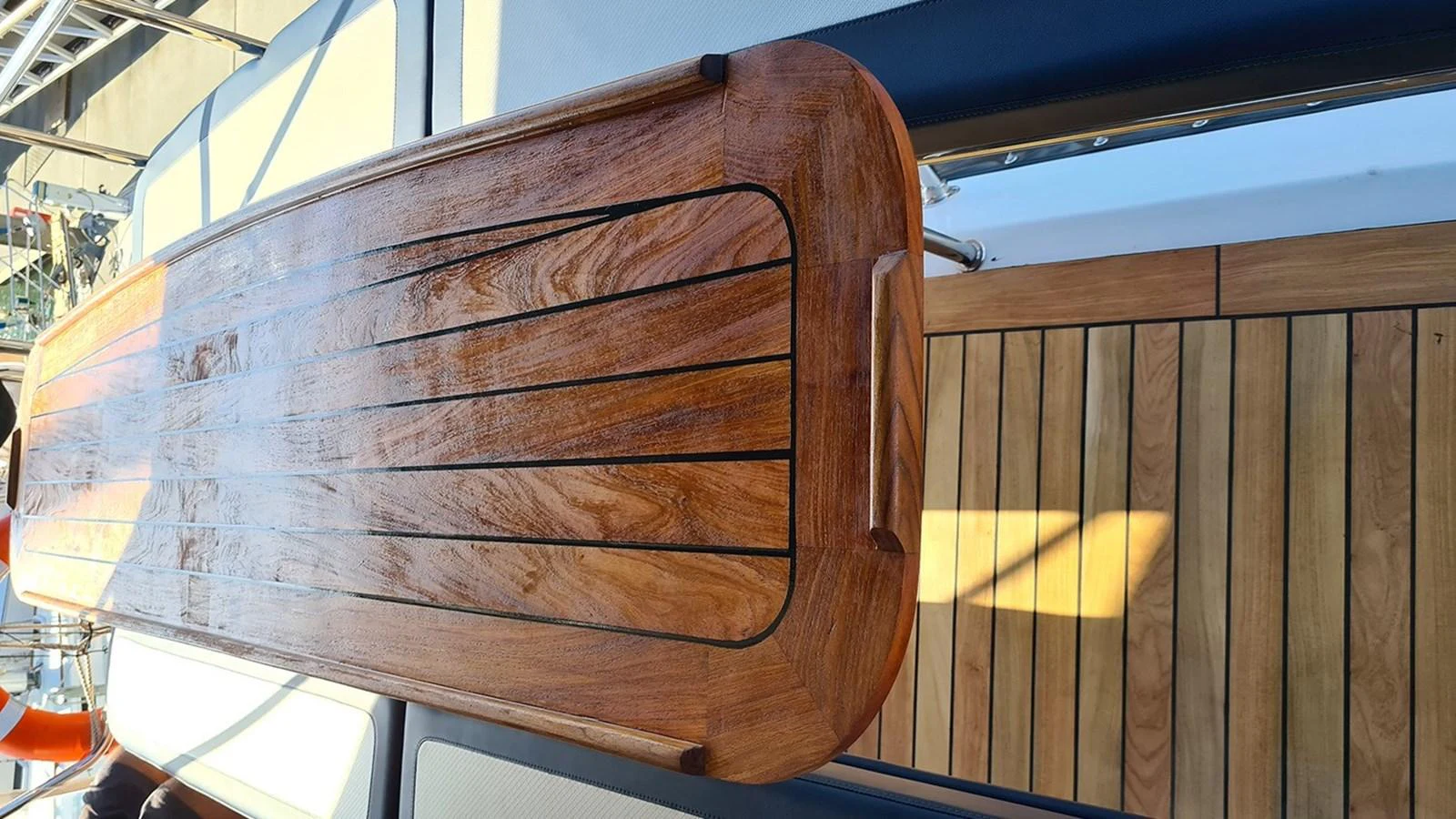 A close-up view of a beautifully crafted wooden table on the yacht's deck. aboard MEGISTI SPIRIT Yacht for Sale