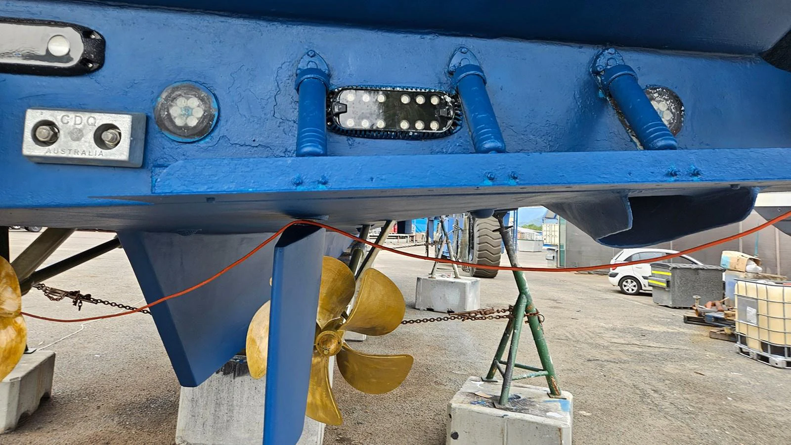 The image showcases the underside of a yacht, highlighting the propellers and underwater lights. aboard MEGISTI SPIRIT Yacht for Sale