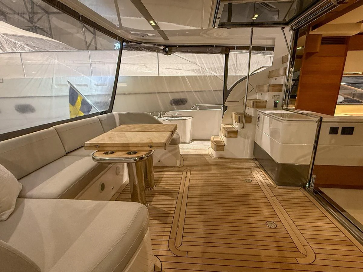 The salon features a spacious seating area with a wooden table and elegant finishes. aboard PRINCESS 70 Yacht for Sale